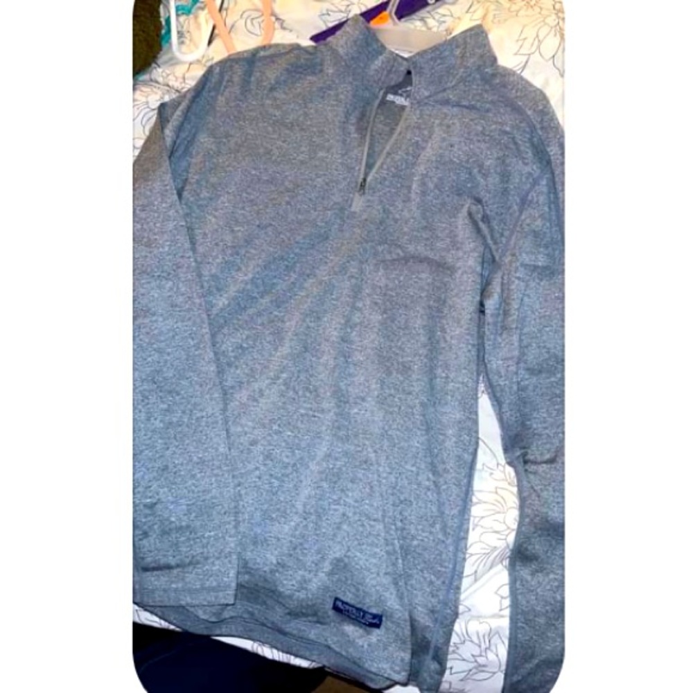 Properly tied quarter zip. Fits more like a large